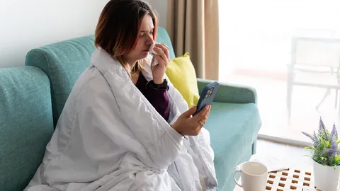 Sick woman having a doctor appointment online at home